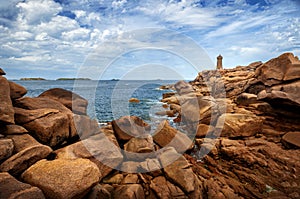 Ploumanach Mean Ruz lighthouse between the rocks in pink granite coast, Perros Guirec, Brittany, France