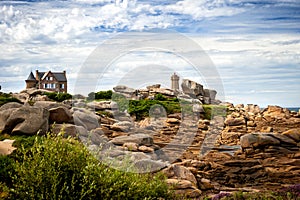 Ploumanac`h Mean Ruz lighthouse between the rocks in pink granite coast, Perros Guirec, Brittany, France.