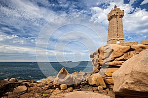 Ploumanac`h Mean Ruz lighthouse between the rocks in pink granite coast, Perros Guirec, Brittany, France.