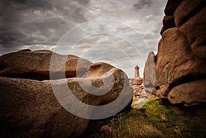 Ploumanac`h Mean Ruz lighthouse between the rocks in pink granite coast, Perros Guirec, Brittany, France.