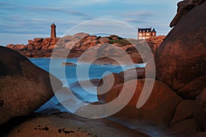 Ploumanach Mean Ruz lighthouse red sunset in pink granite coast, Perros Guirec, Brittany, France.