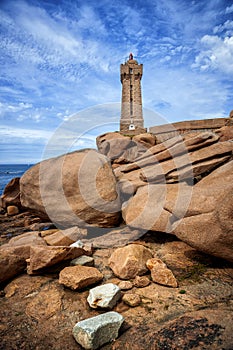 Ploumanach Mean Ruz lighthouse between the rocks in pink granite coast, Perros Guirec, Brittany, France