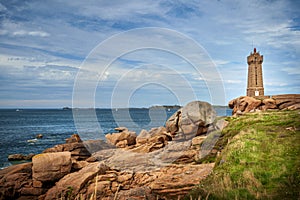 Ploumanach Mean Ruz lighthouse between the rocks in pink granite coast, Perros Guirec, Brittany, France