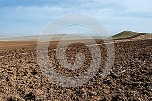 Plowed farm field in mountain valley