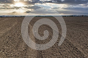 Plowed farm field at the sunset