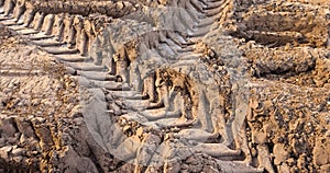 plowed field with frozen ground and traces of agricultural machinery