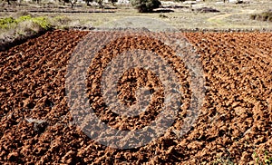 Plowed field in red clay, spain