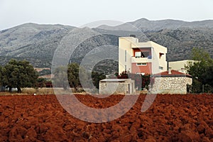 Plowed field with red soil. Crete, Greece