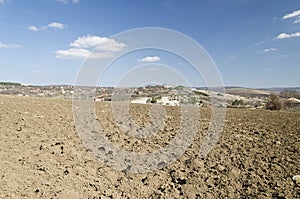 Plowed field in spring with blue sky