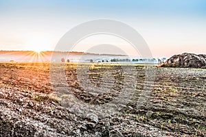 Plowed after harvesting a field near Kiev, Ukraine. Fog over the field early in the morning. A rural landscape with bright colors