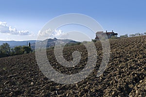 Plowed land with country house