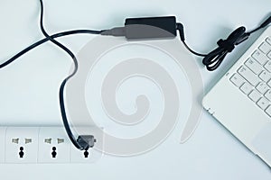 plug in Adapter power cord charger of laptop computer on white background