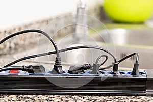 plug in an electrical socket on a worktop at kitchen