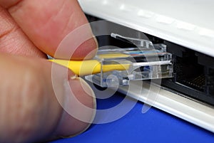 Plug the yellow network cable into the router