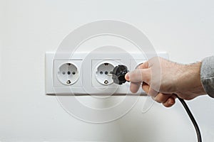 Plugging electrical cable to socket