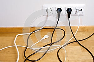 Plugs connected to the outlet in a wall