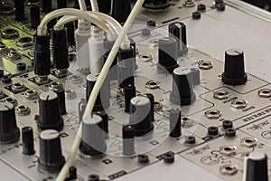 Plugs and knobs - modular synthesizer, analogue synth closeup