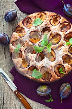 Plum cake over natural wood background