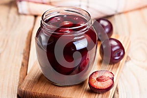Plum compote in a glass jar. photo