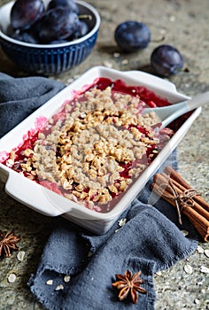 Plum crumble pie with oatmeal in a pan