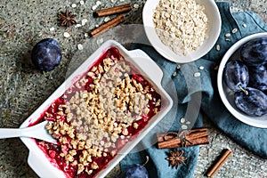 Plum crumble pie with oatmeal in a pan