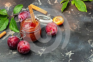 Plum jam and fresh fruits on a dark background. banner, menu, recipe place for text, top view