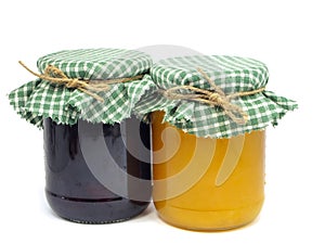 Plum jam and honey in glass jars