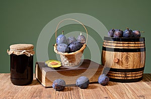 Plum jam in jars and fresh fruits