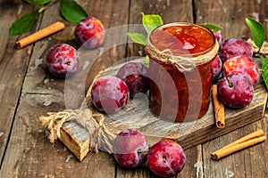 Plum jam nd fresh plums on a wooden background. banner, menu, recipe place for text