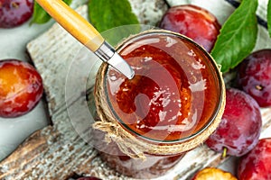 Plum jam nd fresh plums on a wooden background. banner, menu, recipe place for text