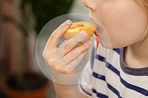 Plum perfection: A child indulges in the perfection of a ripe yellow plum, recognizing the nutritional benefits of this