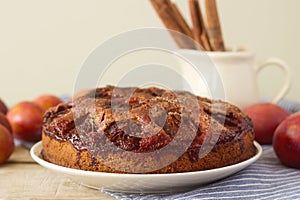 Plum pie or cake with cinnamon and sugar. Plum cake from the newspaper New York Times . Selective focus.