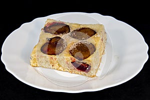 Plum-pie with cinnamon on a white plate