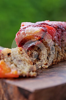 Plum pie. Rustic plum cake on a dark wooden background.