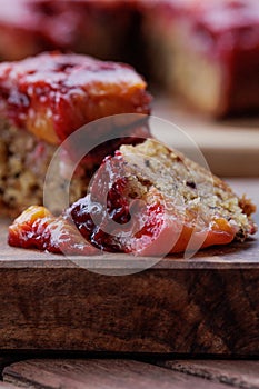 Plum pie. Rustic plum cake on a dark wooden background.