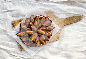 Plum pie on a wooden board photo