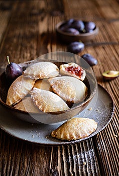 Plum pocket pies studded with powdered sugar