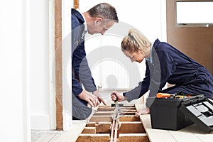 Plumber And Apprentice Fitting Central Heating