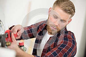 plumber attaches to gas pipe boiler with wrench