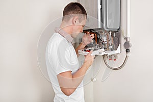 Plumber attaches Trying To Fix the Problem with the Residential Heating Equipment