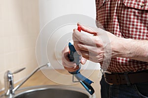 Plumber with caulking gun photo