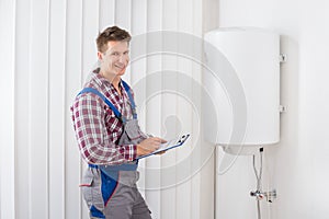 Plumber Checking Electric Boiler