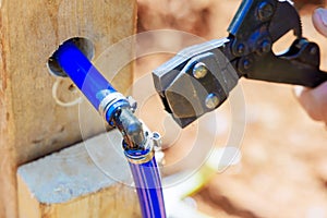 Plumber connects blue PVC pipe for water piping a system