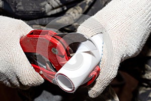 Plumber cuts off a polypropylene pipe for plumbing installation, close-up