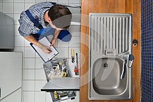 Plumber examining kitchen sink