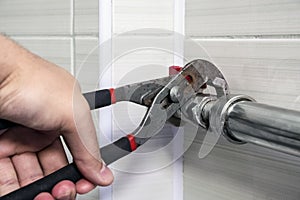 Plumber fixing pipe with adjustable wrench