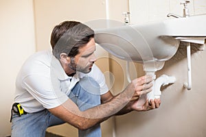 Plumber fixing the sink in a bathroom