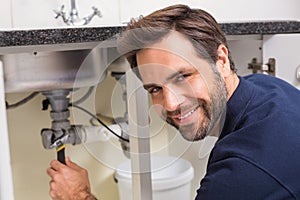 Plumber fixing under the sink