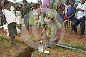 Plumber is gluing PVC pipes dug trench