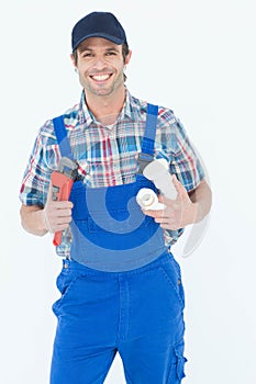 Plumber holding monkey wrench and sink pipe